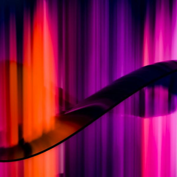 Flowing energy lines in deep pink color on dark background